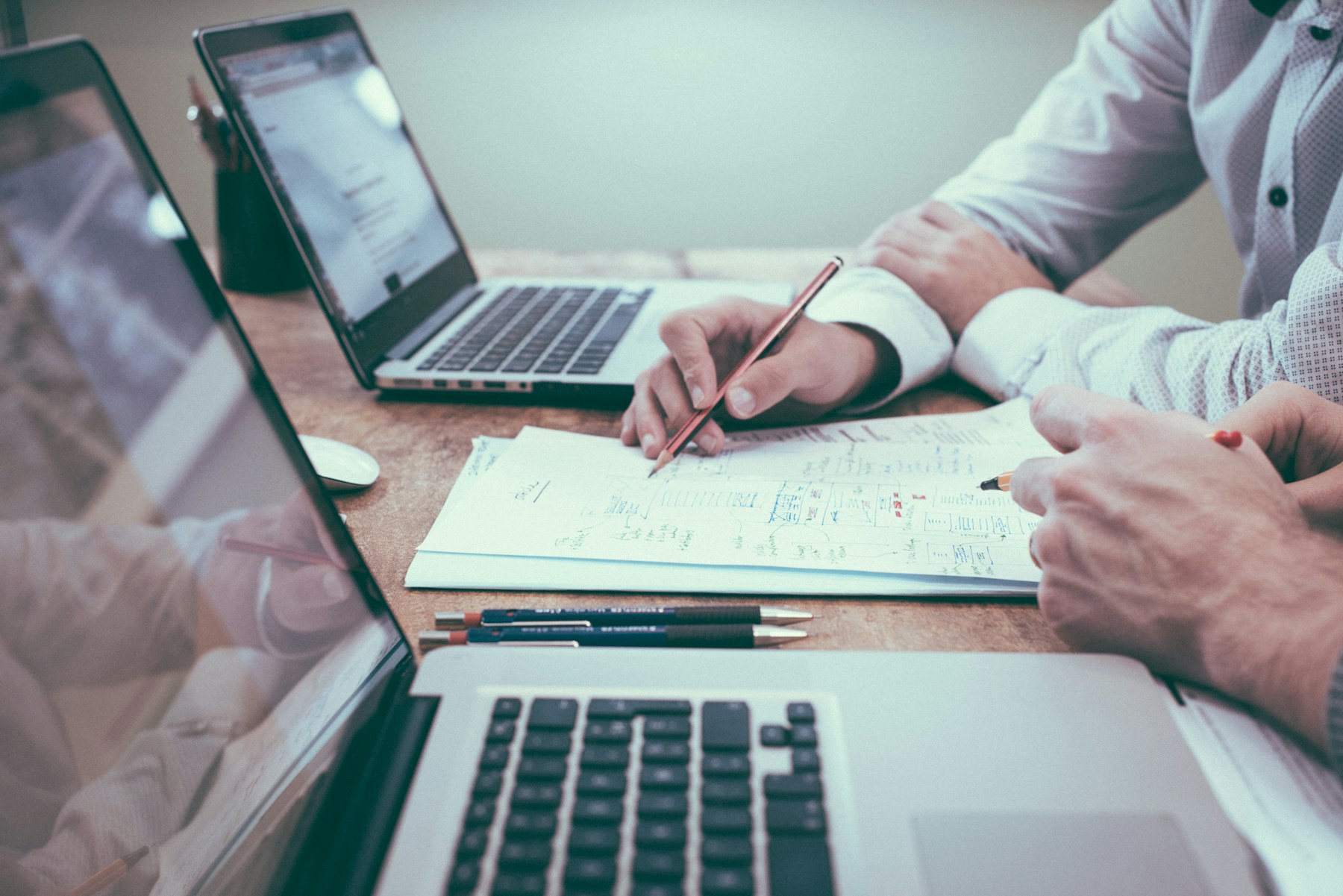 Professionals reviewing documents together at a conference table.